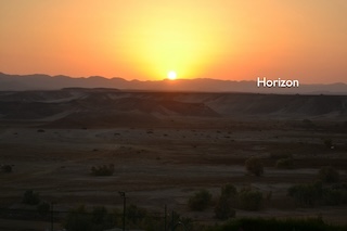 A view of the sunset. The horizon is labeled at the tops of some distant mountains.
